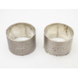 A pair of Art Deco silver napkin rings with engine turned decoration, hallmarked Birmingham 1930,