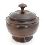 A 20thC treen turned wooden pot and cover / box. Approx. 5 1/4" high Please Note - we do not make