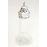 A glass sugar caster with silver mount and top, hallmarked Sheffield 1907, maker Walker & Hall. 7"