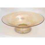 A 20thC iridescent peach-amber glass bowl / charger, measuring 15 1/2" in diameter at the rim Please