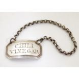 A white metal decanter / wine label / bottle ticket engraved Chilli Vinegar. Approx. 1" wide