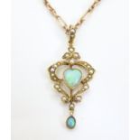 An Art Nouveau 15ct gold pendant set with opals and seed pearls and a yellow metal chain. Approx.