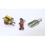 A white metal pendant charm formed as a Beefeater with enamel decoration together with another