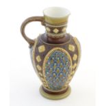 A Mettlach single handled jug with relief foliate decoration. Impressed marks under. Approx. 7 1/