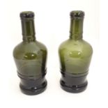 Two olive green glass bottles. Approx 13" high Please Note - we do not make reference to the