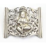 An Eastern white metal brooch depicting a deity within acanthus scroll border. 1 3/4" wide Please