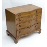 An early 19thC mahogany serpentine fronted chest of drawers, having four long graduated drawers with