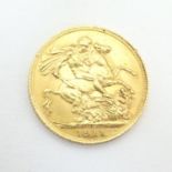 Coin : A 1911 George V gold sovereign. Please Note - we do not make reference to the condition of