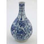 A Chinese blue and white Kraak style bottle vase with panelled decoration depicting figures and