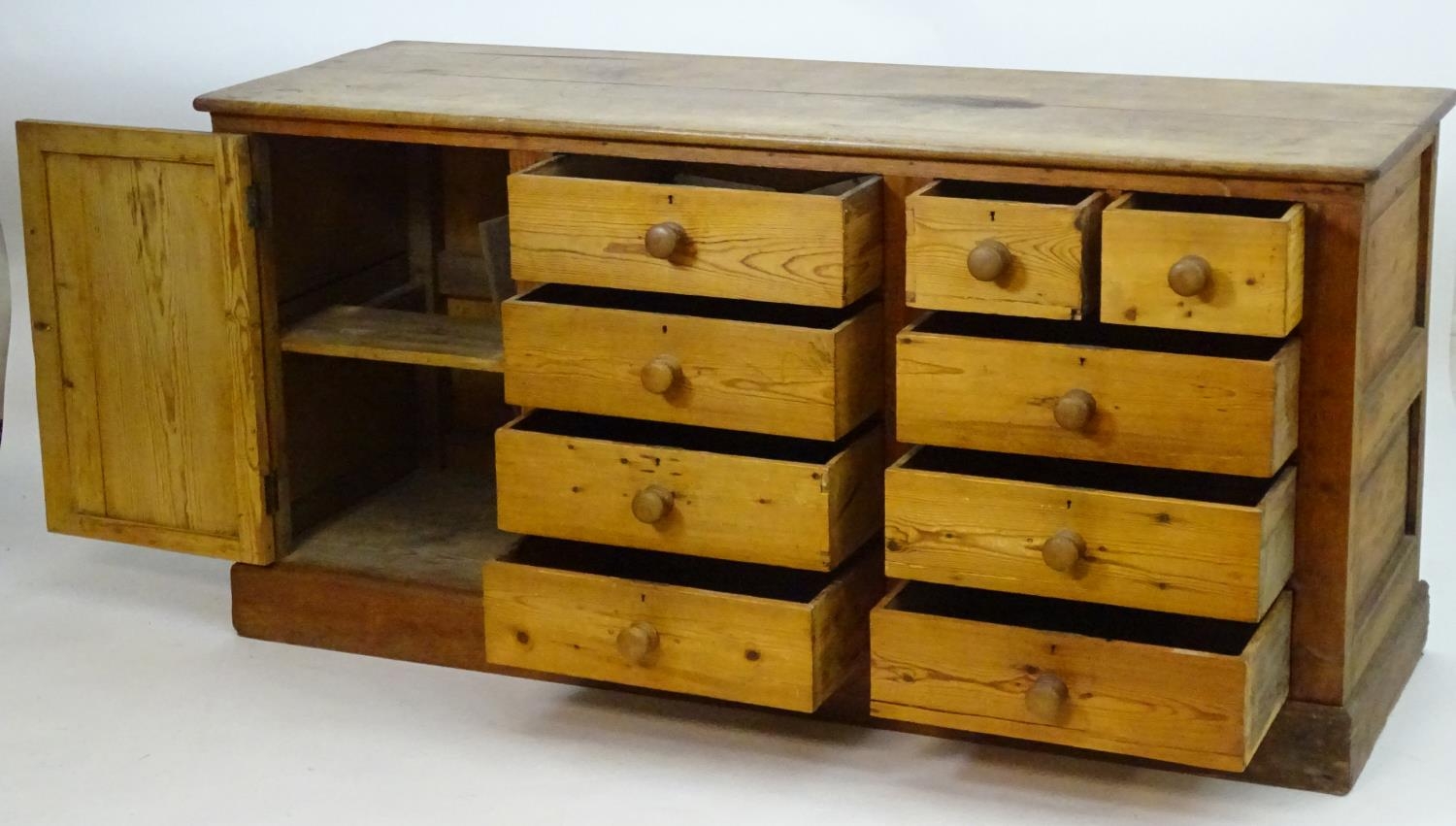 A late 19thC pine dresser base with a moulded rectangular top above a single cupboard, seven short - Image 3 of 7