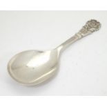 A silver caddy spoon with Tudor rose decoration to handle, hallmarked Birmingham 1960, maker J. B.