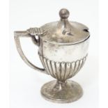 A Victorian silver mustard pot with fluted decoration and pedestal base, hallmarked Sheffield