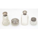 Four assorted glass dressing table pots with silver lids to include examples hallmarked Birmingham