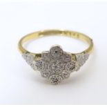 An 18ct gold ring set with central diamond bordered by 4 further diamonds in a platinum setting.