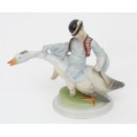 A Herend pottery model of Ludas Matyia / Mattie the Goose-Boy, depicting a young boy riding a goose.