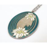 A silver pendant of oval form with floral enamel detail. Hallmarked Birmingham 1977 maker Franklin