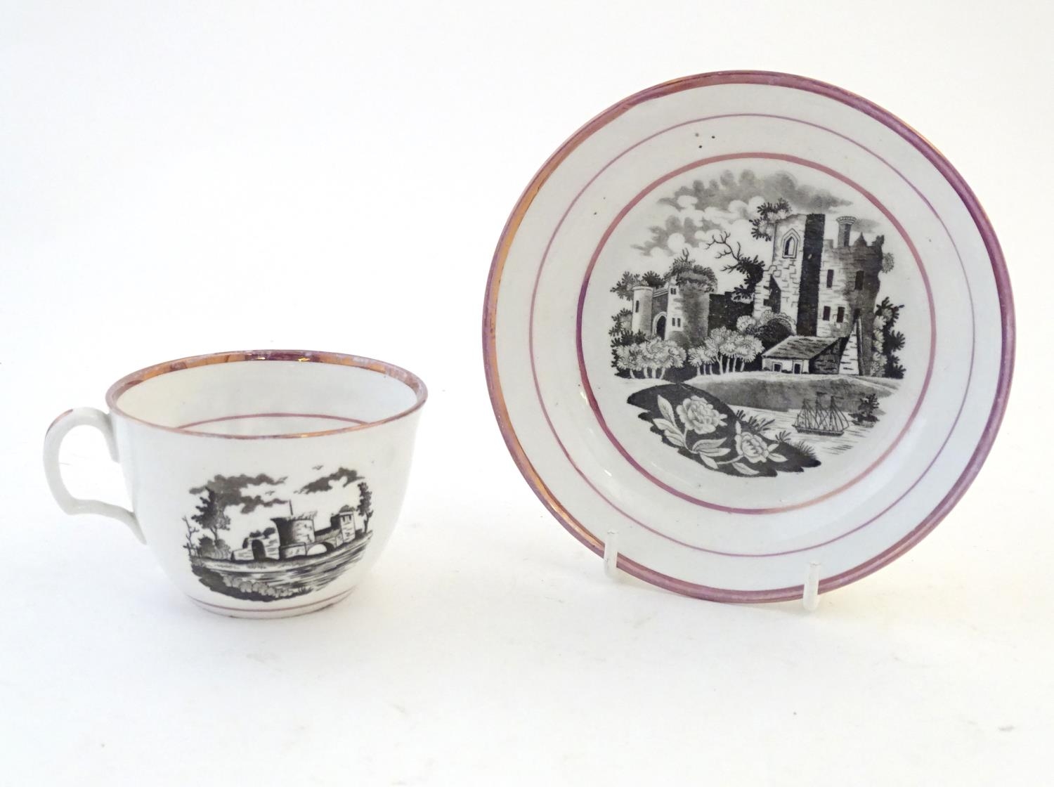 A tea cup and saucer with monochrome transfer decoration depicting a river landscape with a ship and - Image 3 of 6