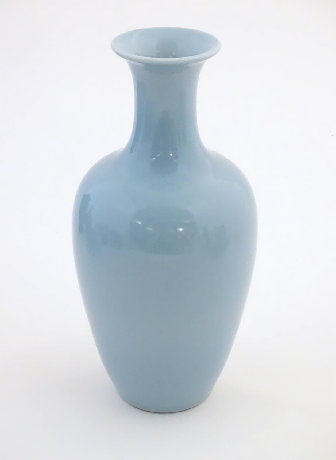 A Chinese celadon style vase of baluster form. Character marks under. Approx. 11" high Please Note -