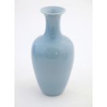 A Chinese celadon style vase of baluster form. Character marks under. Approx. 11" high Please Note -