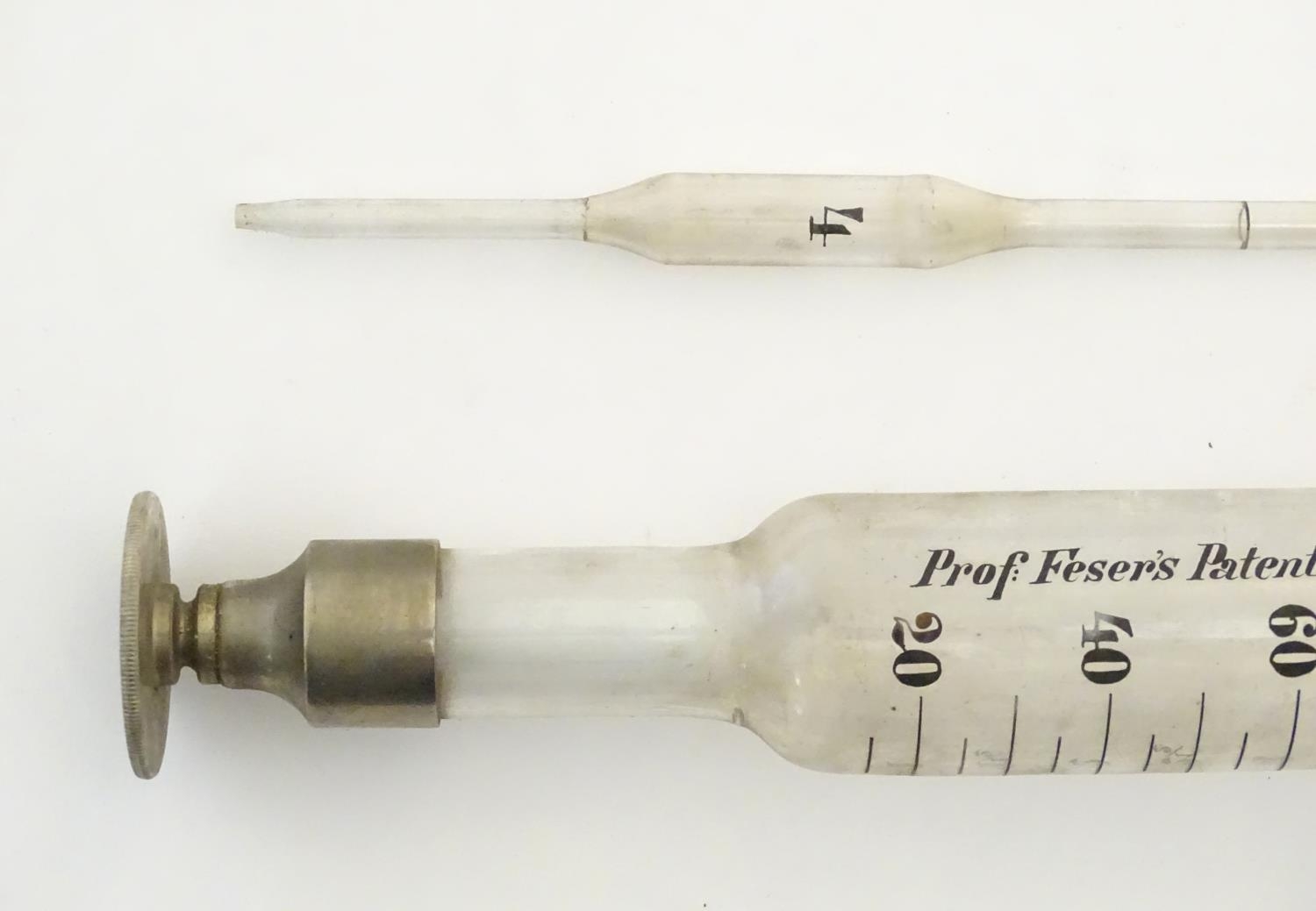 A 20thC cased glass Lactoscope with metal base, the interior with label: 'Professor Feser's Patent - Image 6 of 7