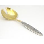 A Russian silver gilt salad server 8" long Please Note - we do not make reference to the condition