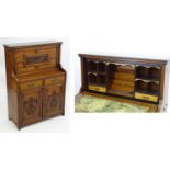 A late 19thC fall front walnut bureau with a carved front above two small drawers and two panelled