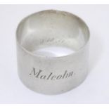 A silver napkin ring, hallmarked Birmingham 1919, maker Joseph Gloster Ltd. Engraved 'Malcolm'