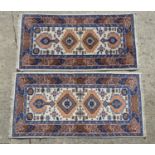 Carpet / Rug : Two rugs with central motifs on a cream ground, with geometric borders. Each approx