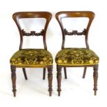 A pair of 19thC mahogany balloon back side chairs, with carved mid rails above shaped upholstered