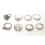 Eight assorted silver and white metal rings with various decoration. (8) Please Note - we do not