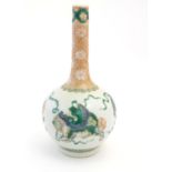 A Chinese bottle vase decorated with stylised foo dogs / dragons. The neck with floral and foliate