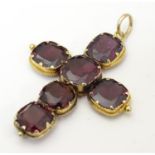 A late 19thC / early 20thC gold pedant of cross form set with 6 garnets. 1 1/2" long Please Note -