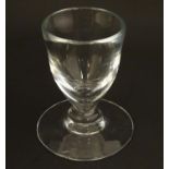 A drinking glass with wide foot. 4 1/2" high Please Note - we do not make reference to the condition