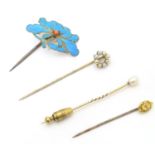 A Chinese gilt metal kingfisher feather hair pin / stick pin, set with coral coloured bead to