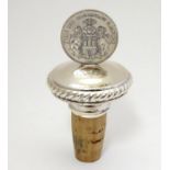 A Continental 925 silver mounted bottle stopper, the handle formed as a 1911 German coin. 4" high