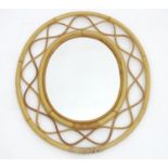 Vintage retro, mid century: a wall hanging oval mirror with bentwood bamboo frame, 21 3/4" tall