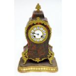 A 19thC French tortoiseshell Boulle work mantle clock with ormolu mounts and surmounted by a brass