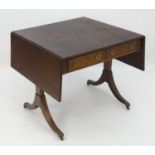 A late 18thC / early 19thC mahogany sofa table with a rectangular top above two short drawers with