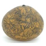 A late 19th / early 20thC South American gourd profusely engraved with animals to include armadillo,