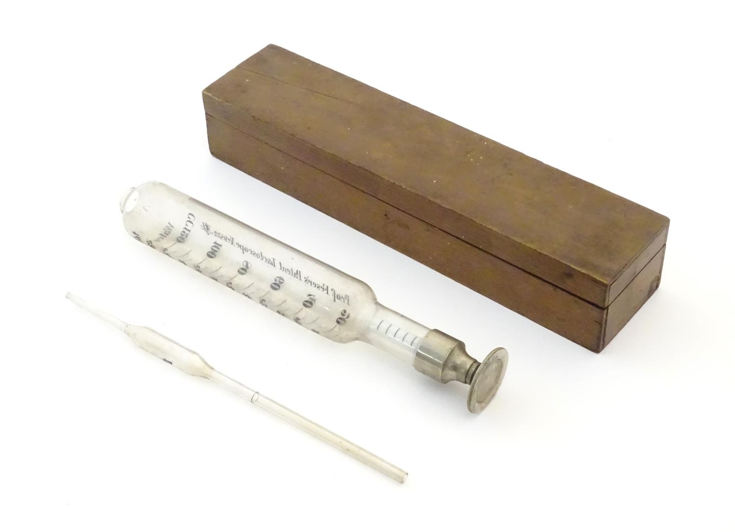 A 20thC cased glass Lactoscope with metal base, the interior with label: 'Professor Feser's Patent - Image 3 of 7
