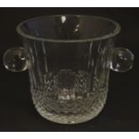 An early 20thC lead crystal ice bucket, decorated with roundel, blade and diamond cuts, standing