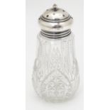 A cut glass sugar shaker / caster with a silver lid, hallmarked London 1925. Approx. 5 1/4" high