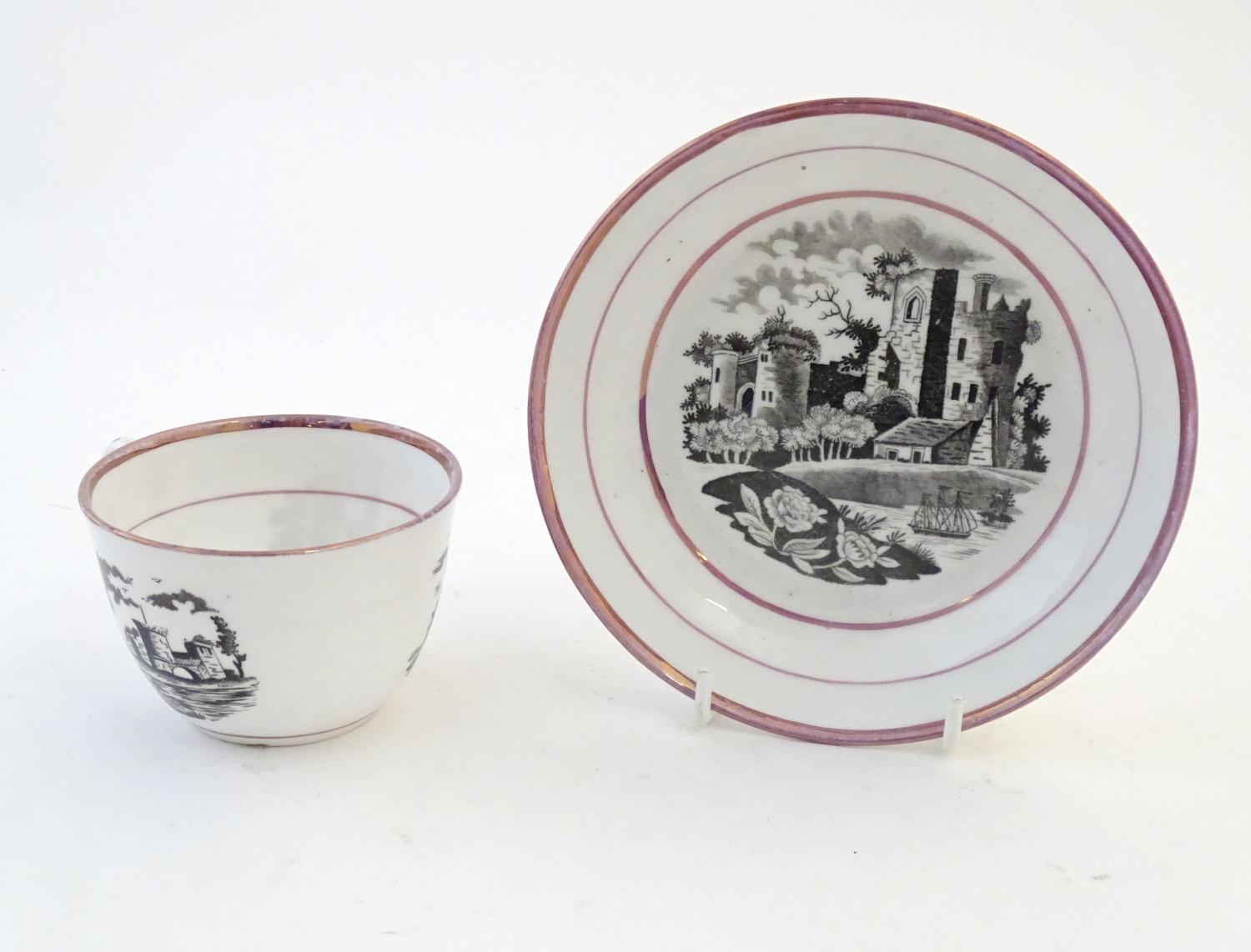 A tea cup and saucer with monochrome transfer decoration depicting a river landscape with a ship and - Image 6 of 6