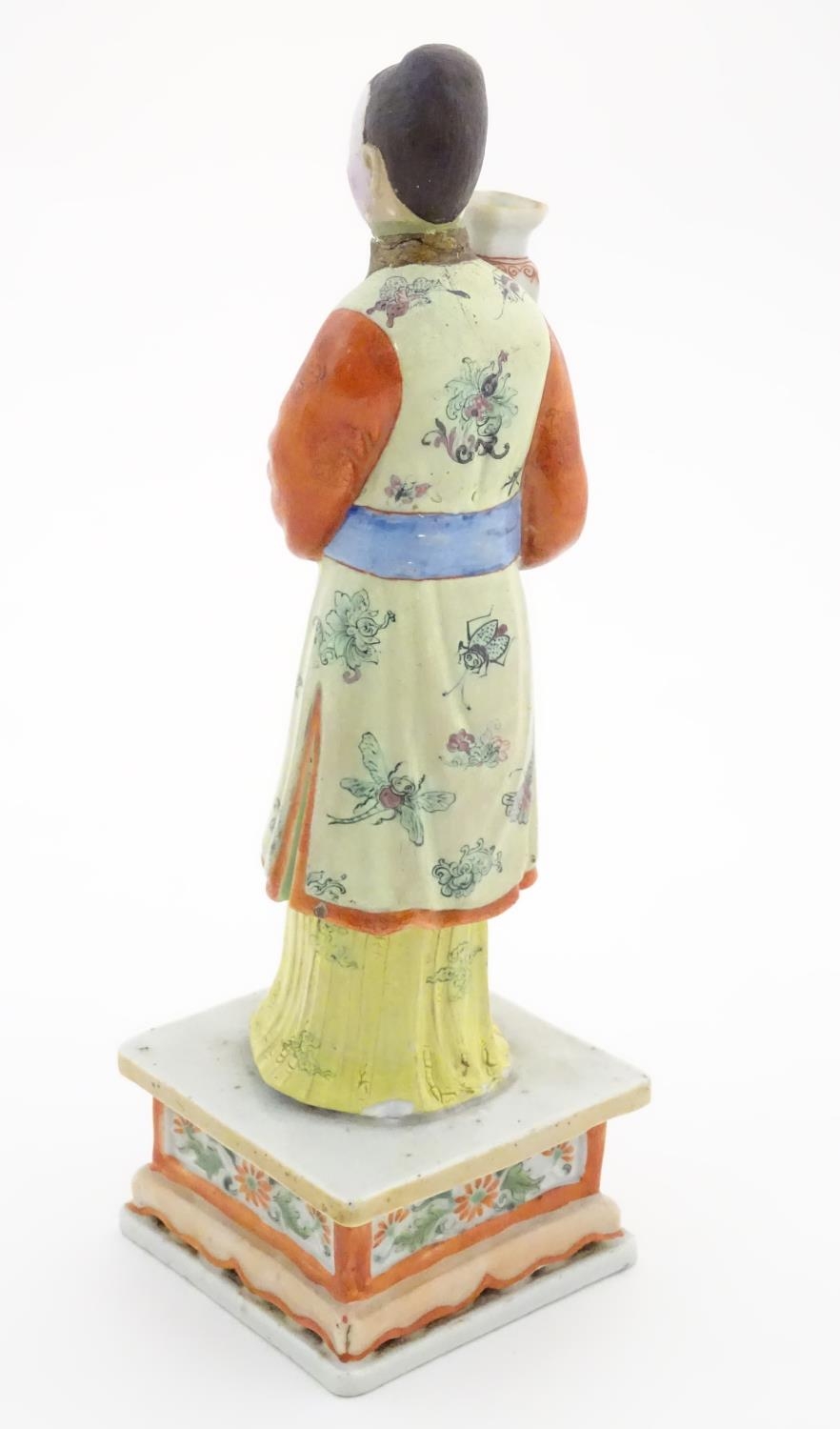 An Oriental porcelain model of a male figure wearing a kimono with butterfly and floral detail - Image 4 of 8