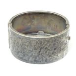 A silver bangle formed bracelet with engraved foliate detail Hallmarked Birmingham 1936 maker Kirwan