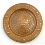 A mid 20thC Arts & Crafts style copper charger with embossed detail. Approx. 17 1/4" diameter Please