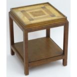 An Art Deco coffee table of unusual construction timbers and a sample wood top, standing on four