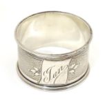 A silver napkin ring with engine turned decoration, hallmarked Sheffield 1901, maker Walker & Hall
