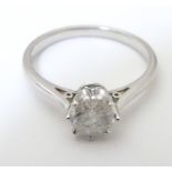 An 18ct white gold diamond solitaire ring. The diamond approx 1ct ( 1/4" diameter). Ring size approx