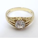 A 9ct gold ring set with central white stone solitaire. Ring size approx. size R Please Note - we do